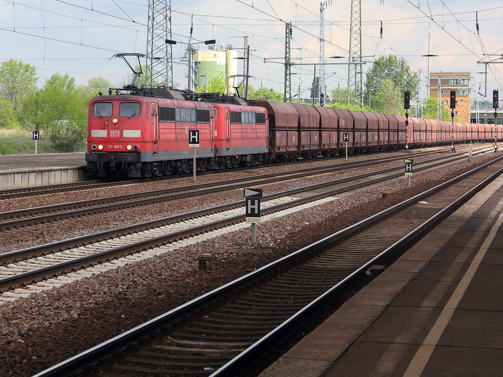 151 168-2 und 151 100-5 mit einem Ganzzug Sch�ttgutwagen  passieren am 04. Mai 2012   auf Gleis 4  den Bahnhof Berlin Sch�nefeld Flughafen.